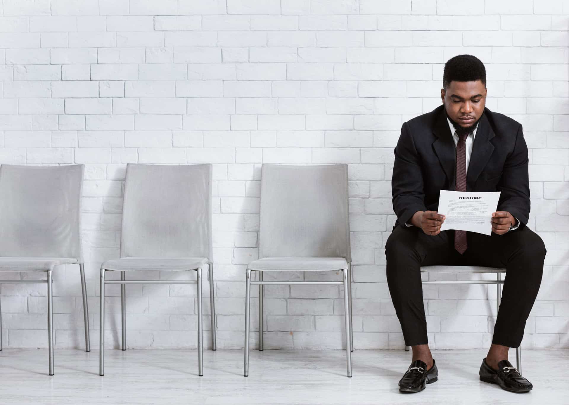 Man waiting for job interview at First Choice Staffing hiring event.