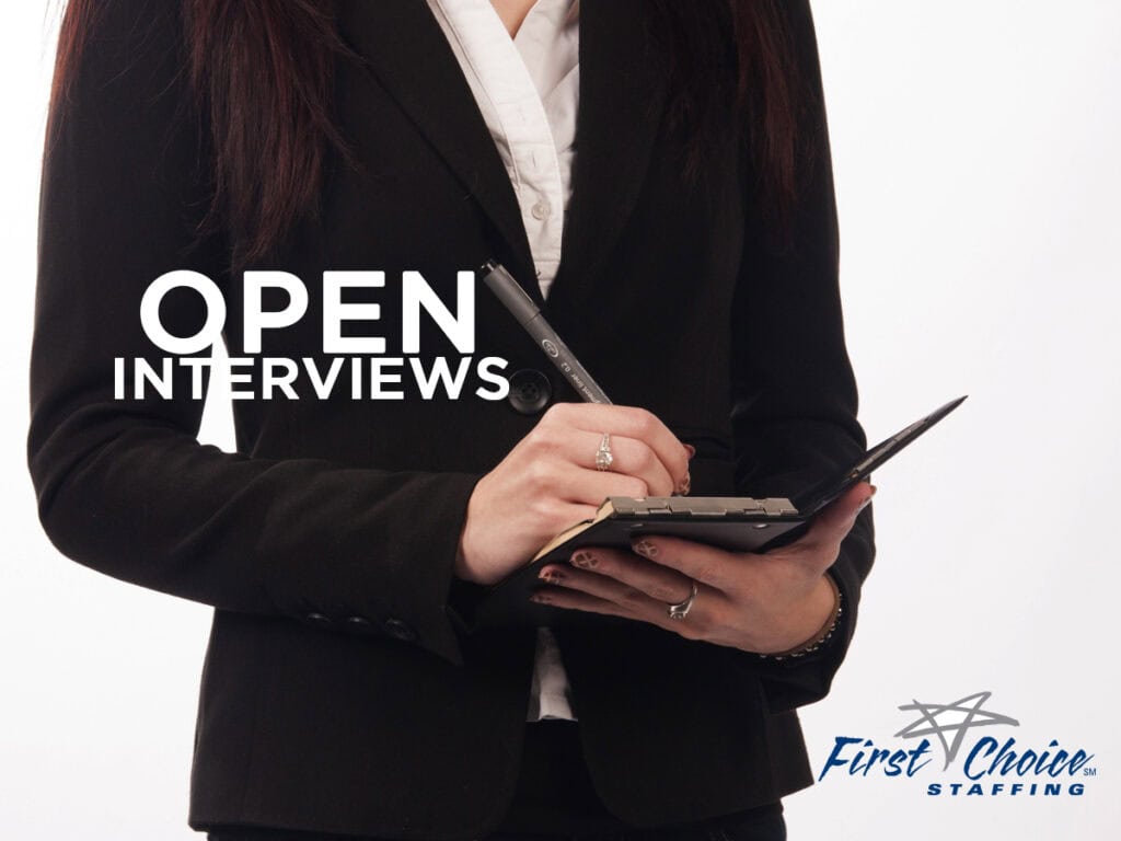 Person in professional blazer writing notes with a pen and the words Open Interviews in white lettering overlay