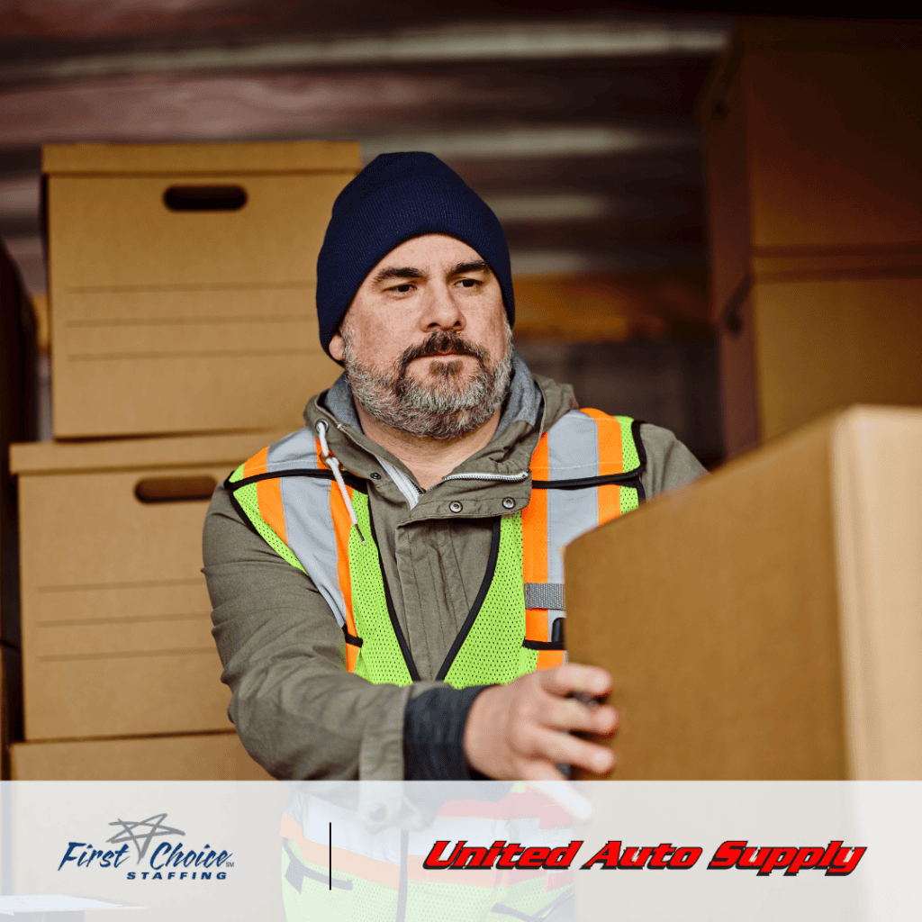 Male warehouse worker operating unloading a truck