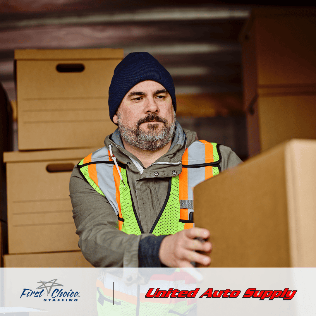 Male warehouse worker operating unloading a truck
